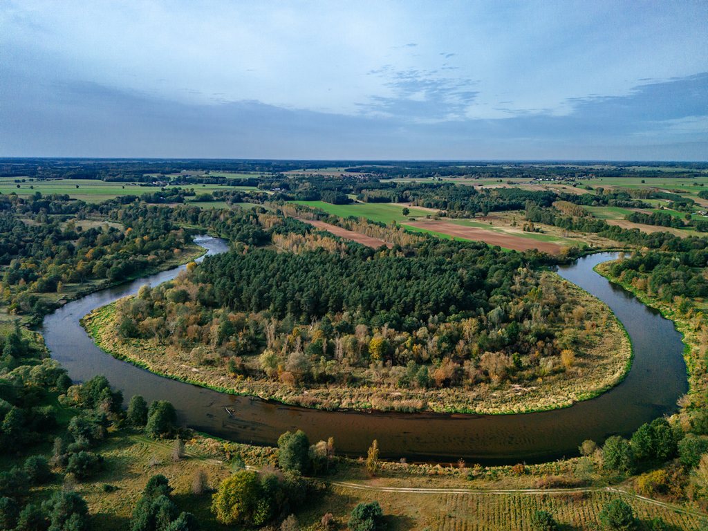 Drone view - the meandering Warta river among fields and forests.
