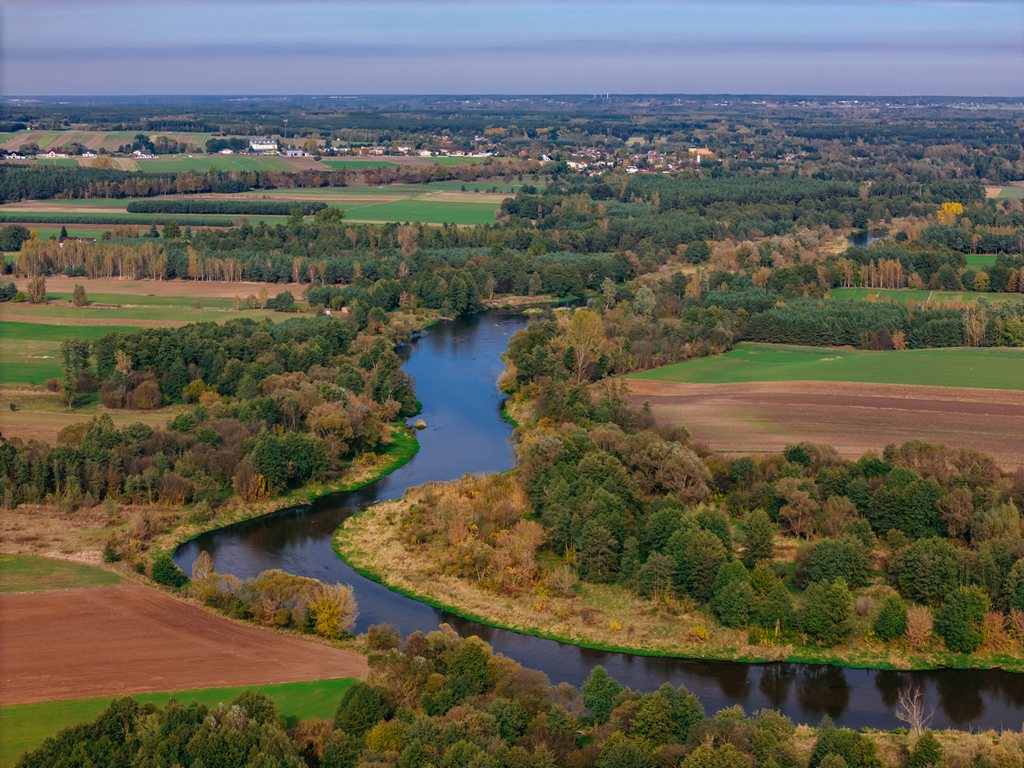 Drone view - the meandering Warta river among fields and forests
