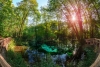 A large limestones quarry surrounded by greenery.